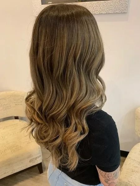 Woman With Wavy, Highlighted Hair — Artistry Of Hair in Redlynch, QLD