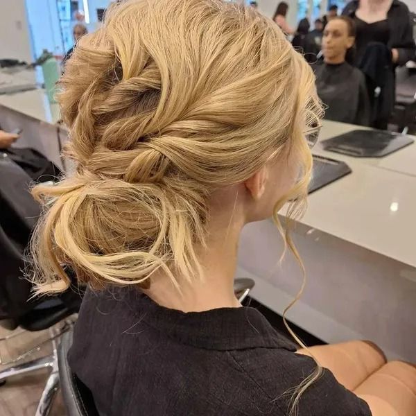 Blonde Hair Styled in an Updo at a Salon, With Twists and a Low Bun — Artistry Of Hair in Redlynch, QLD