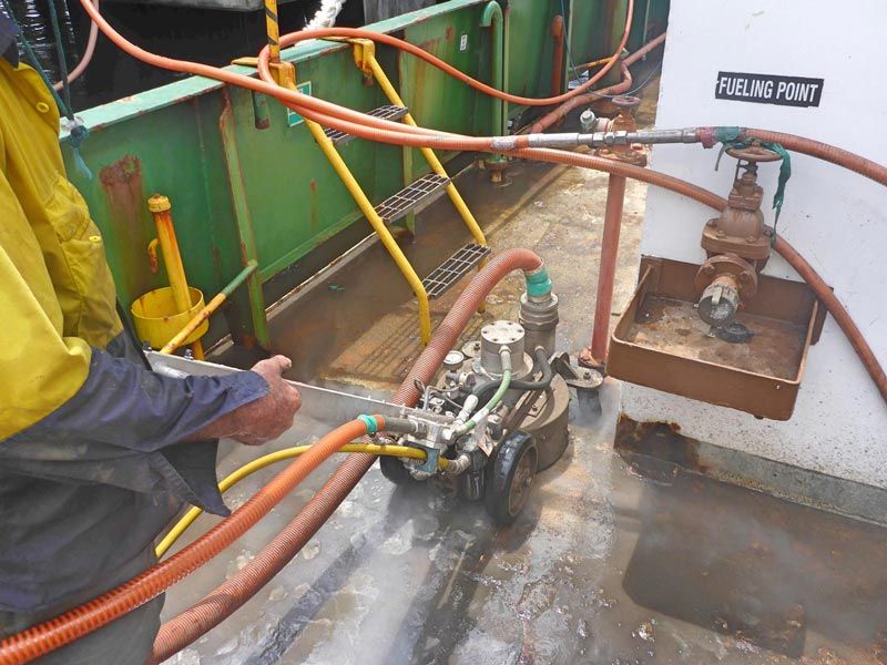 man operating rolling waterblaster