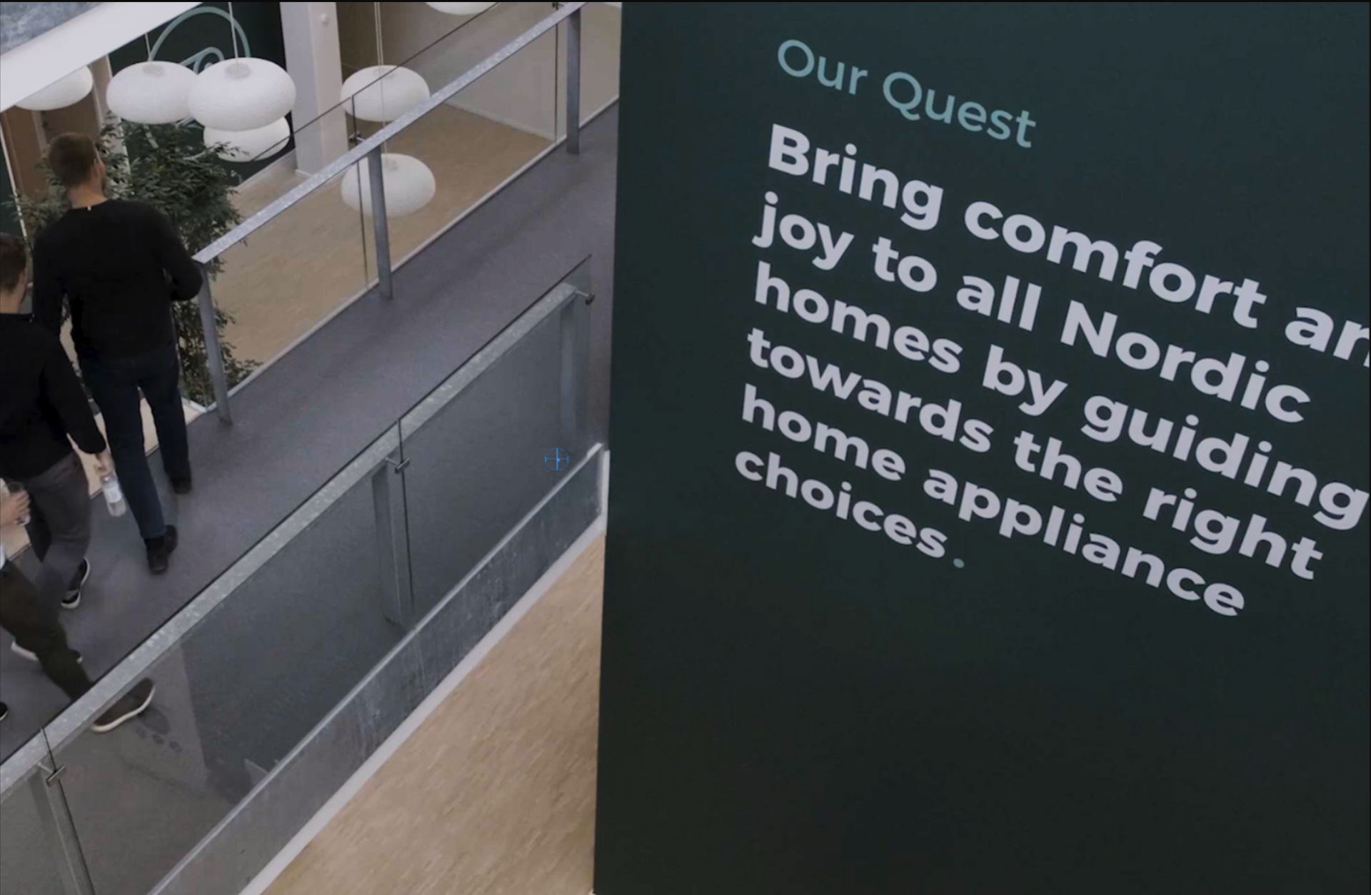 People walking by a sign with text: 