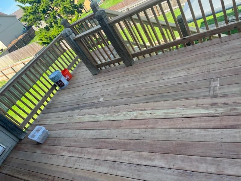 Wooden deck with railings and buckets.