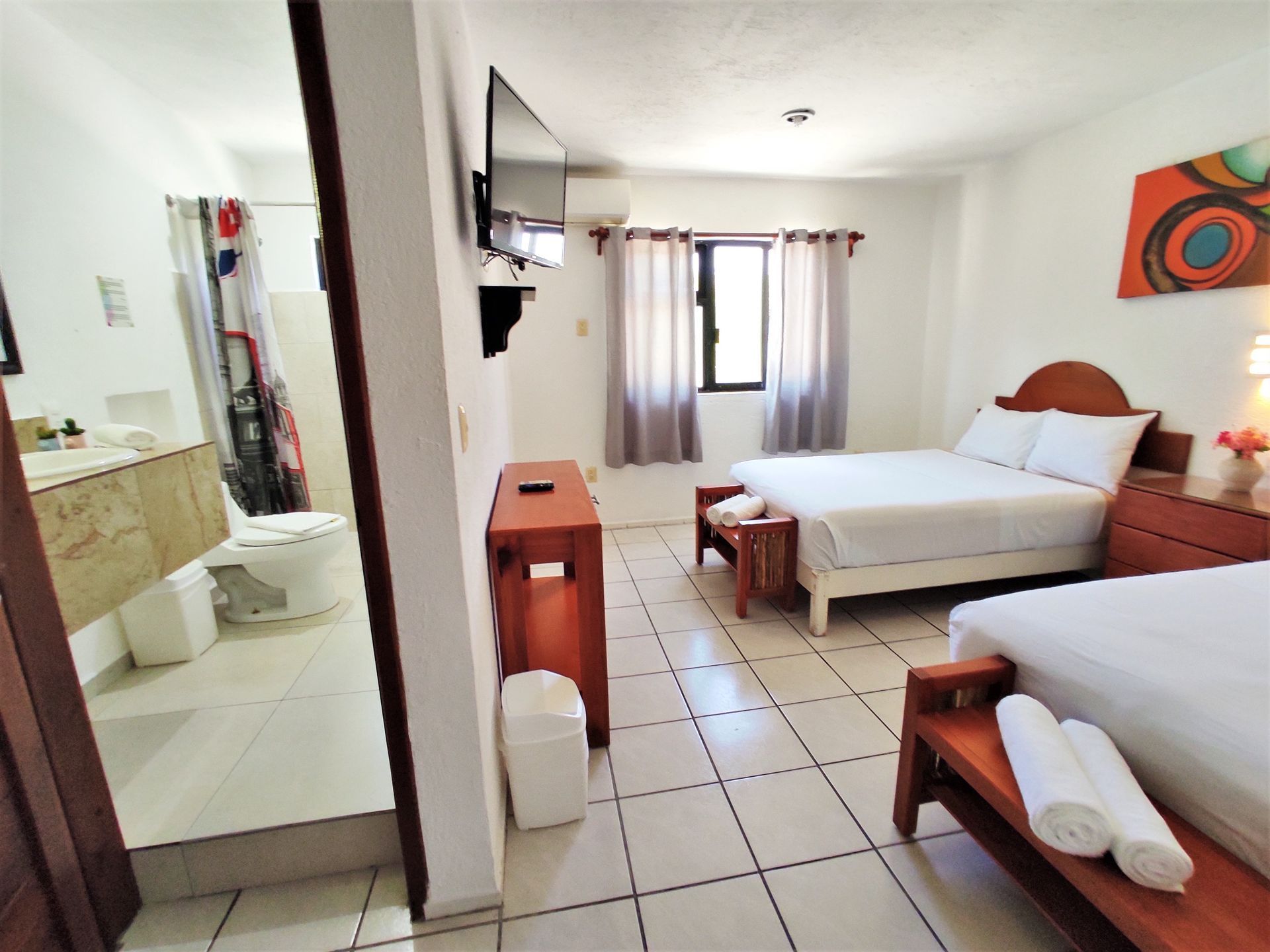 A hotel room with two beds and a bathroom