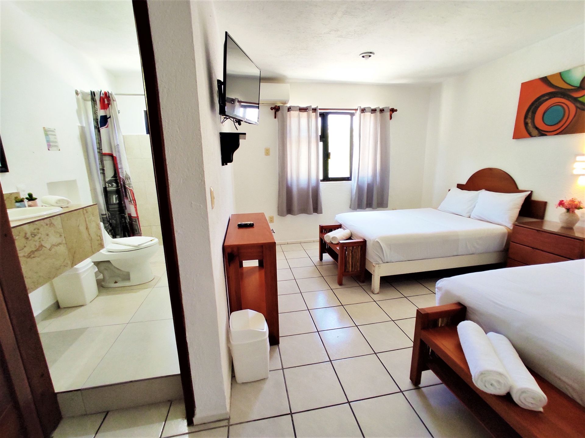 A hotel room with two beds and a bathroom