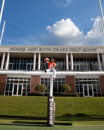 Mebane Field House at Mercer University with a red statue in front under a blue sky