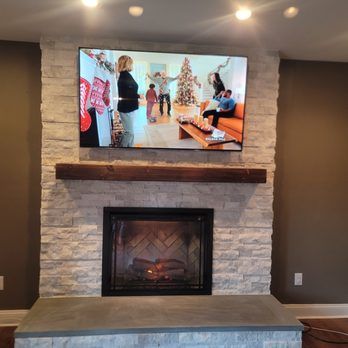 A fireplace with a flat screen tv above it.