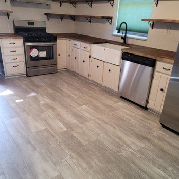 A kitchen with stainless steel appliances and white cabinets