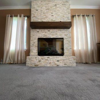 A living room with a fireplace and a flat screen tv.