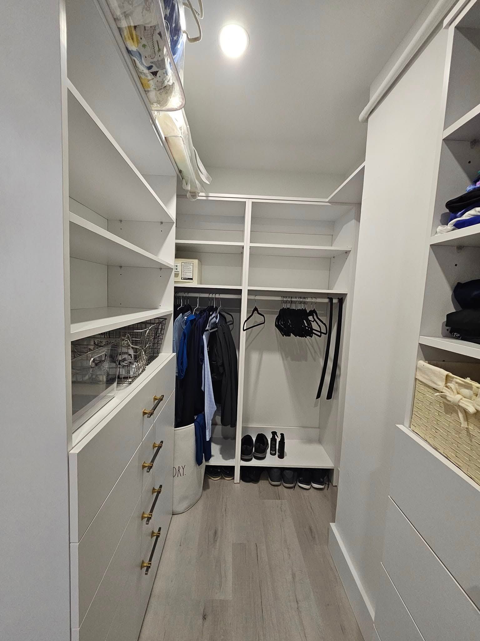 A walk in closet filled with clothes and shoes.