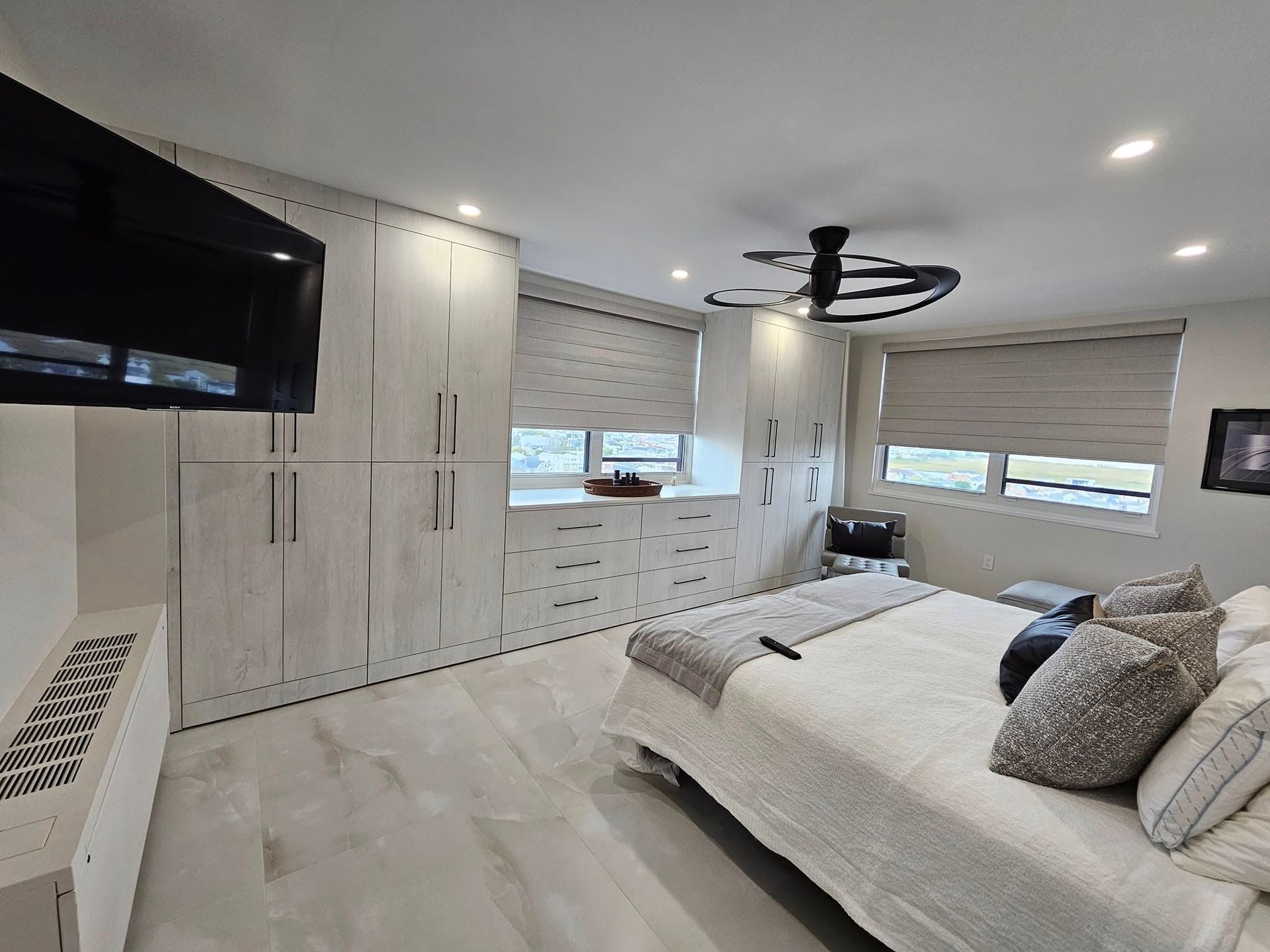A bedroom with a large bed and a flat screen tv