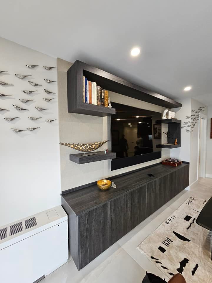 A living room with a large flat screen tv on the wall.