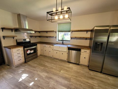 A kitchen with stainless steel appliances and wooden cabinets.