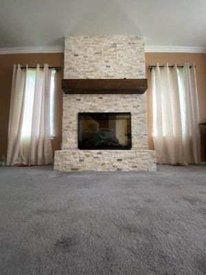 A living room with a fireplace and a flat screen tv.