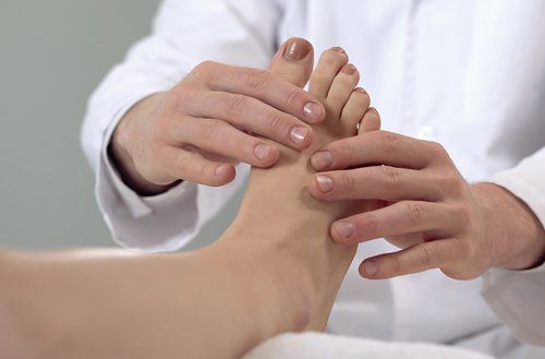 Doctor Examining Patient Foot — Fresno, CA — Dr. Brent L Woodbury DPM