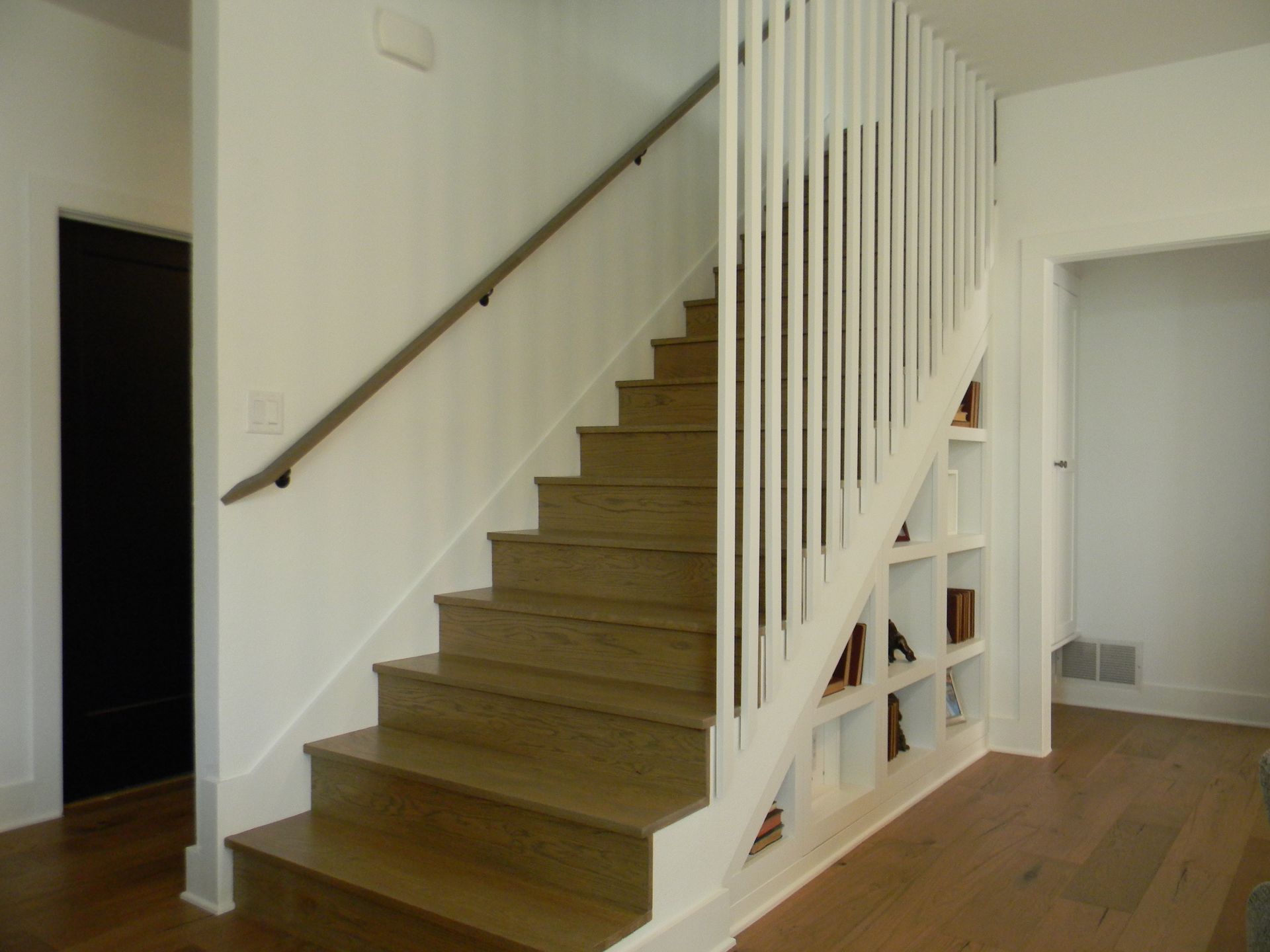 A staircase with wooden steps and a white railing