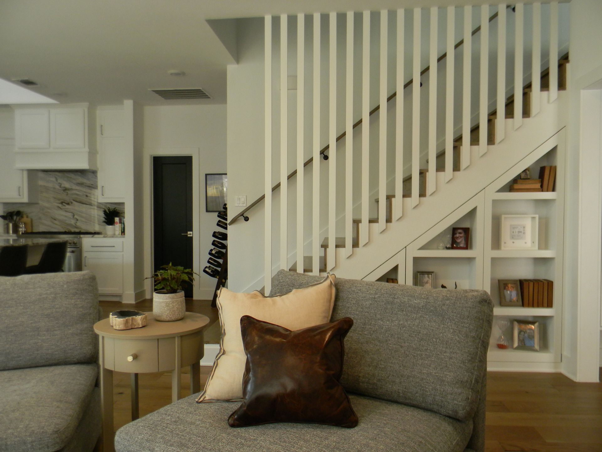A living room with a couch and stairs in the background