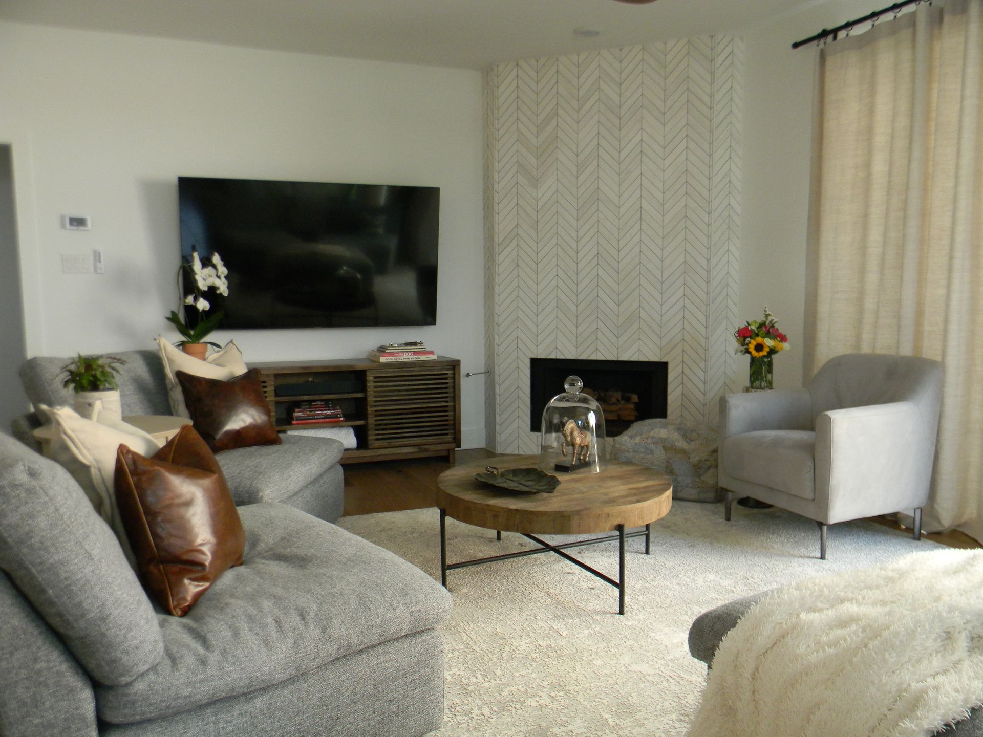 A living room with a fireplace and a flat screen tv