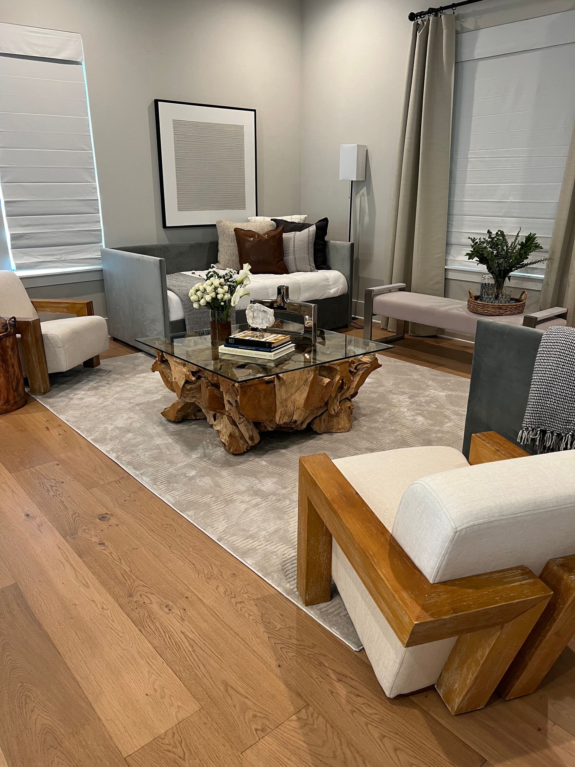 A living room with a couch , chairs , and a coffee table.