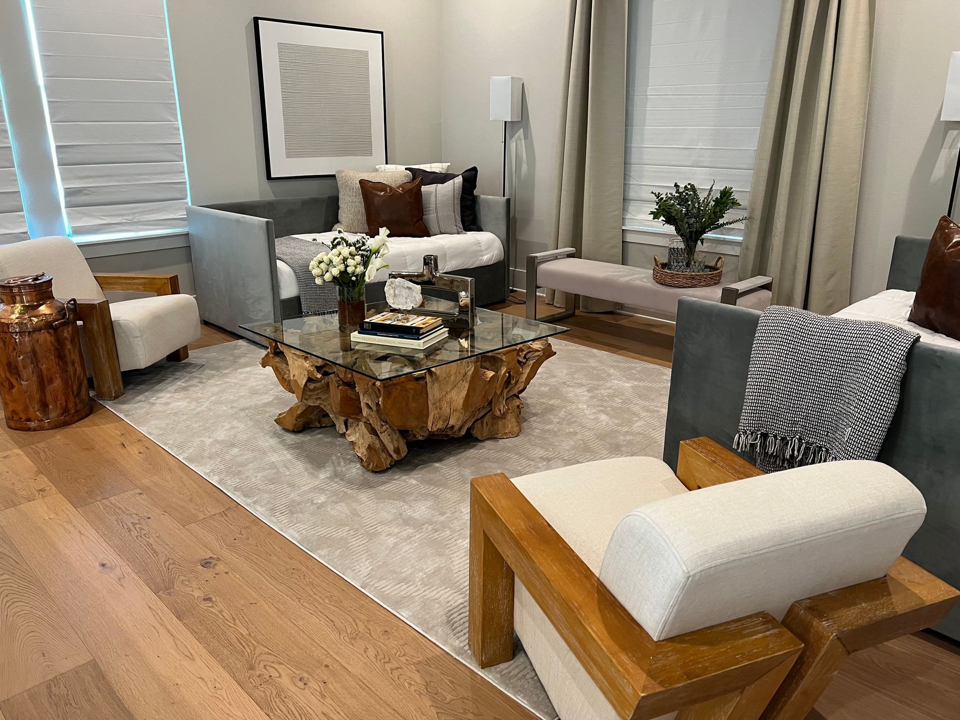 A living room with a couch , chairs , and a coffee table.