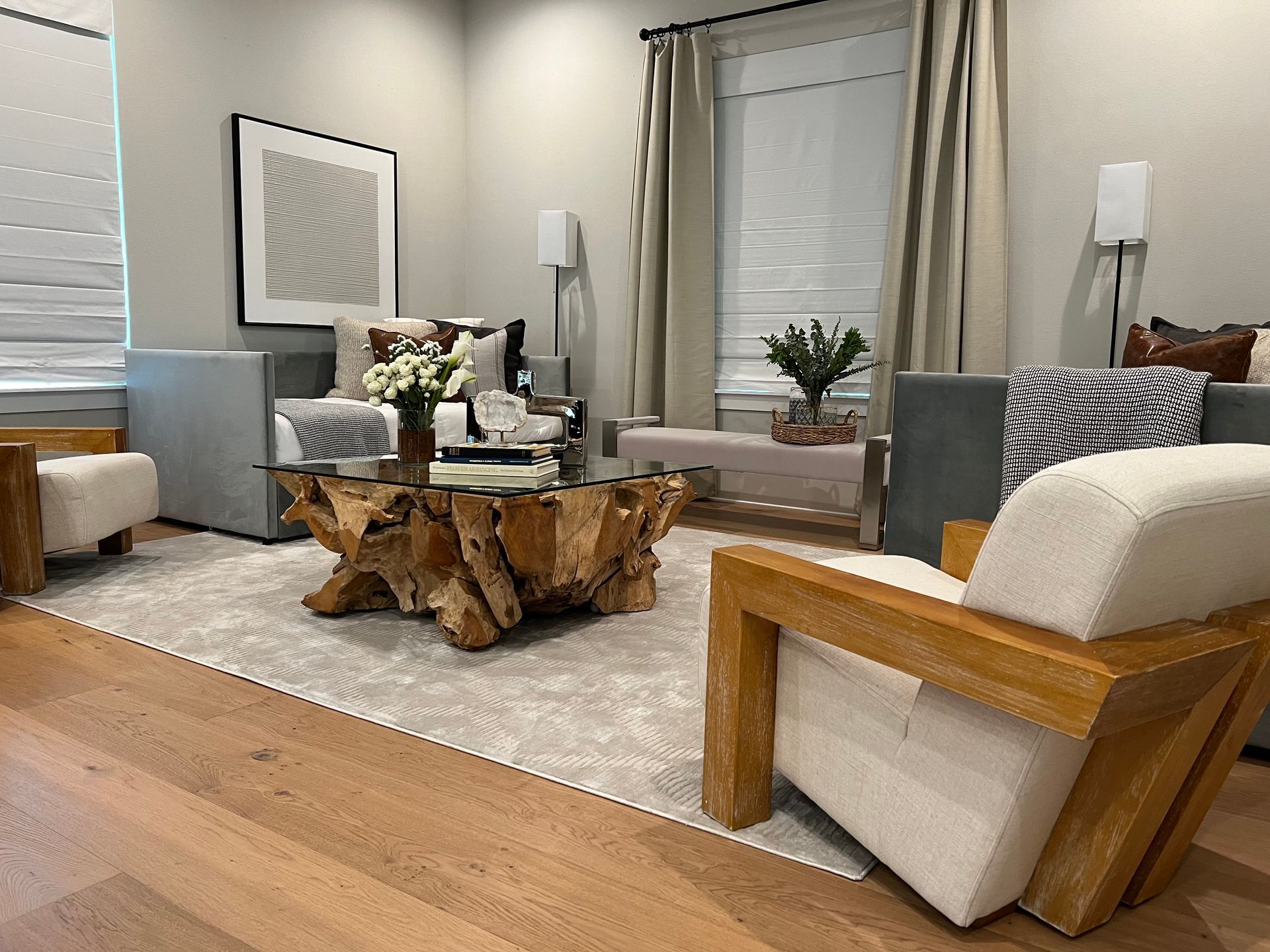 A living room with a wooden coffee table and chairs.