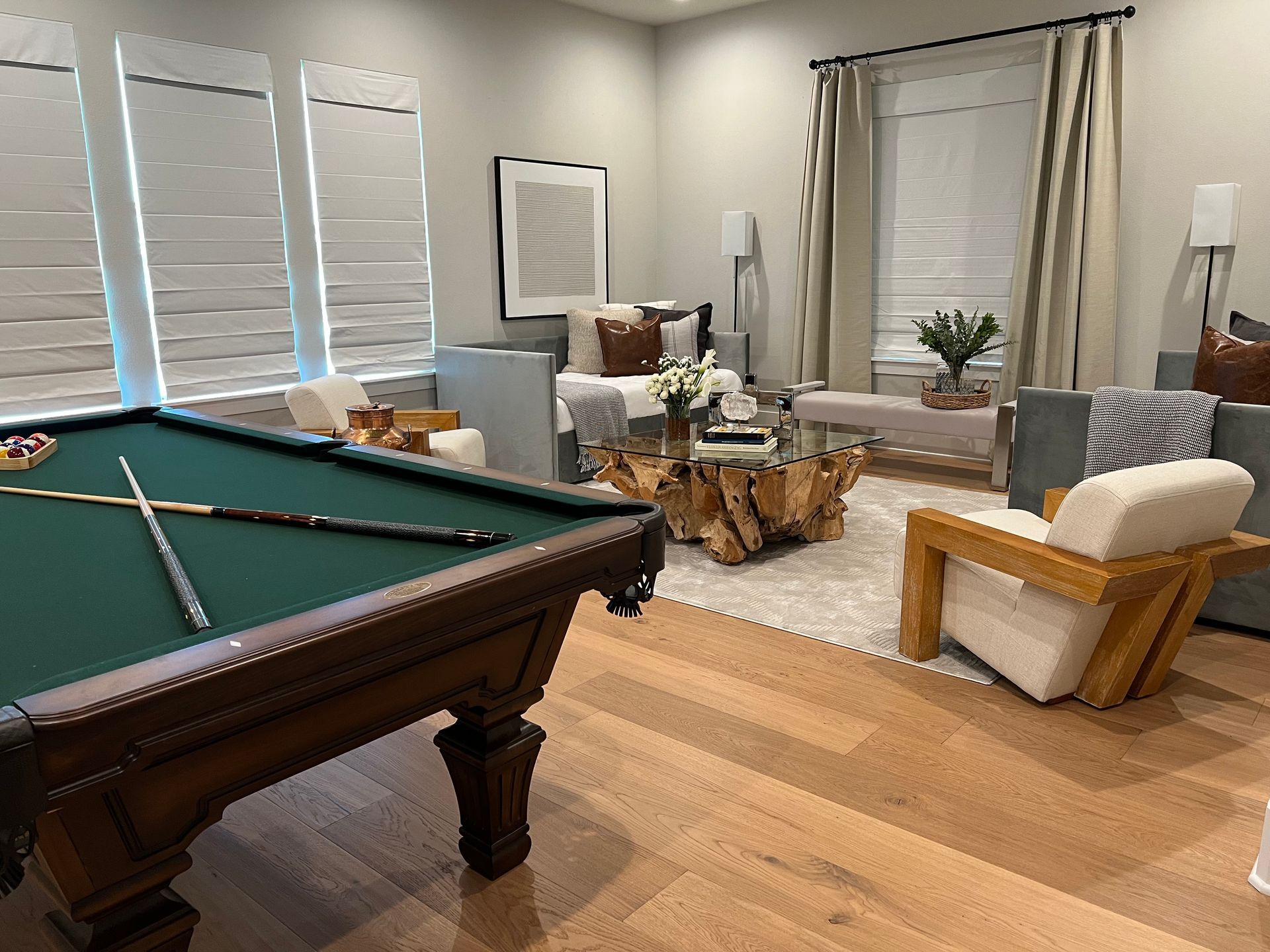 There is a pool table in the middle of the living room.