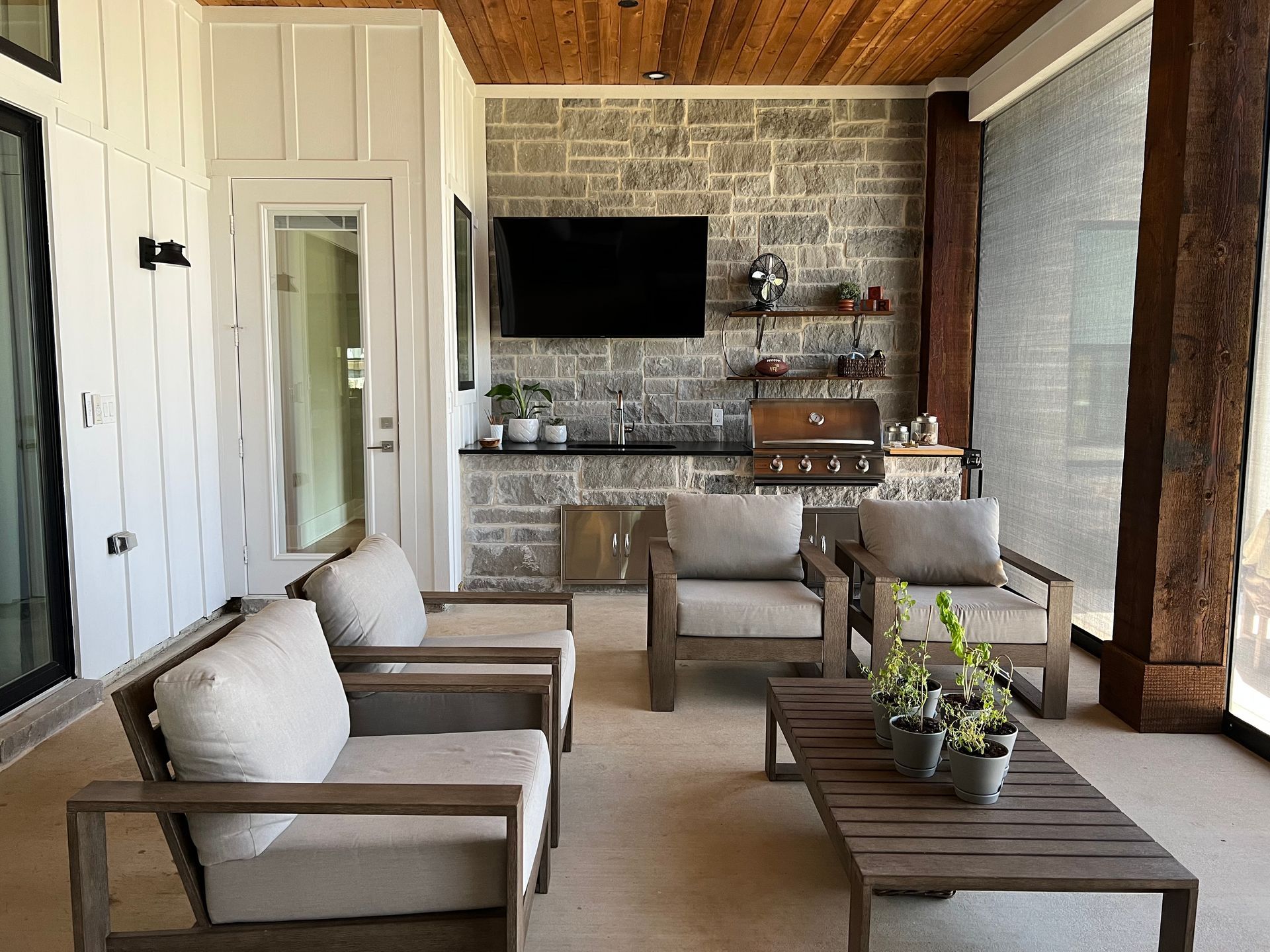 A living room with chairs , a table and a flat screen tv.