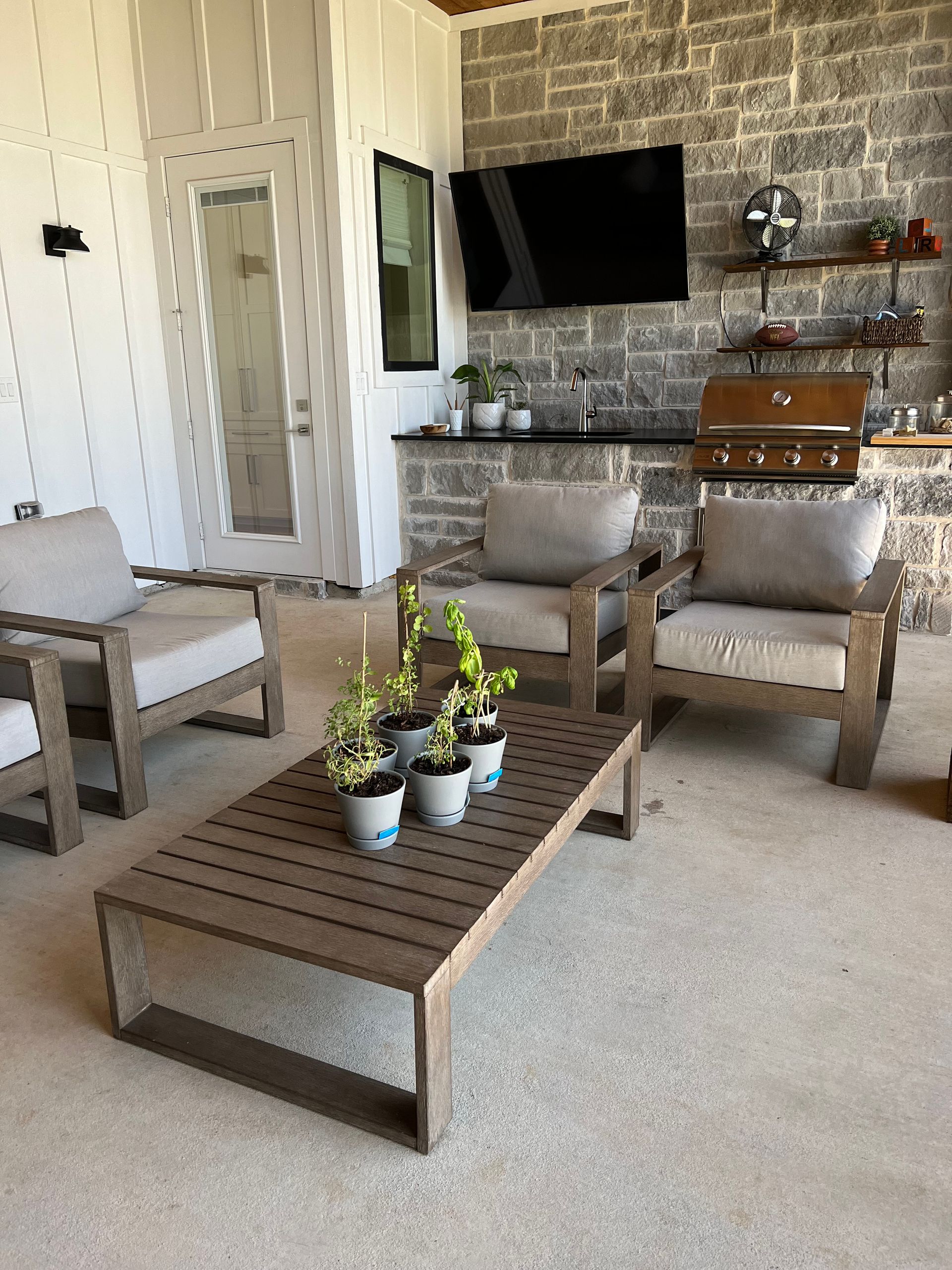 A living room with a table , chairs , and a television.