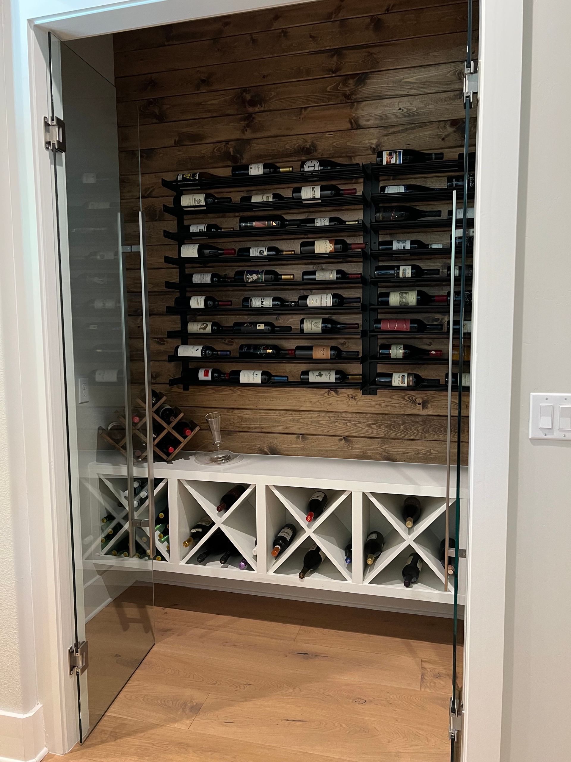 A wine cellar filled with lots of bottles of wine.