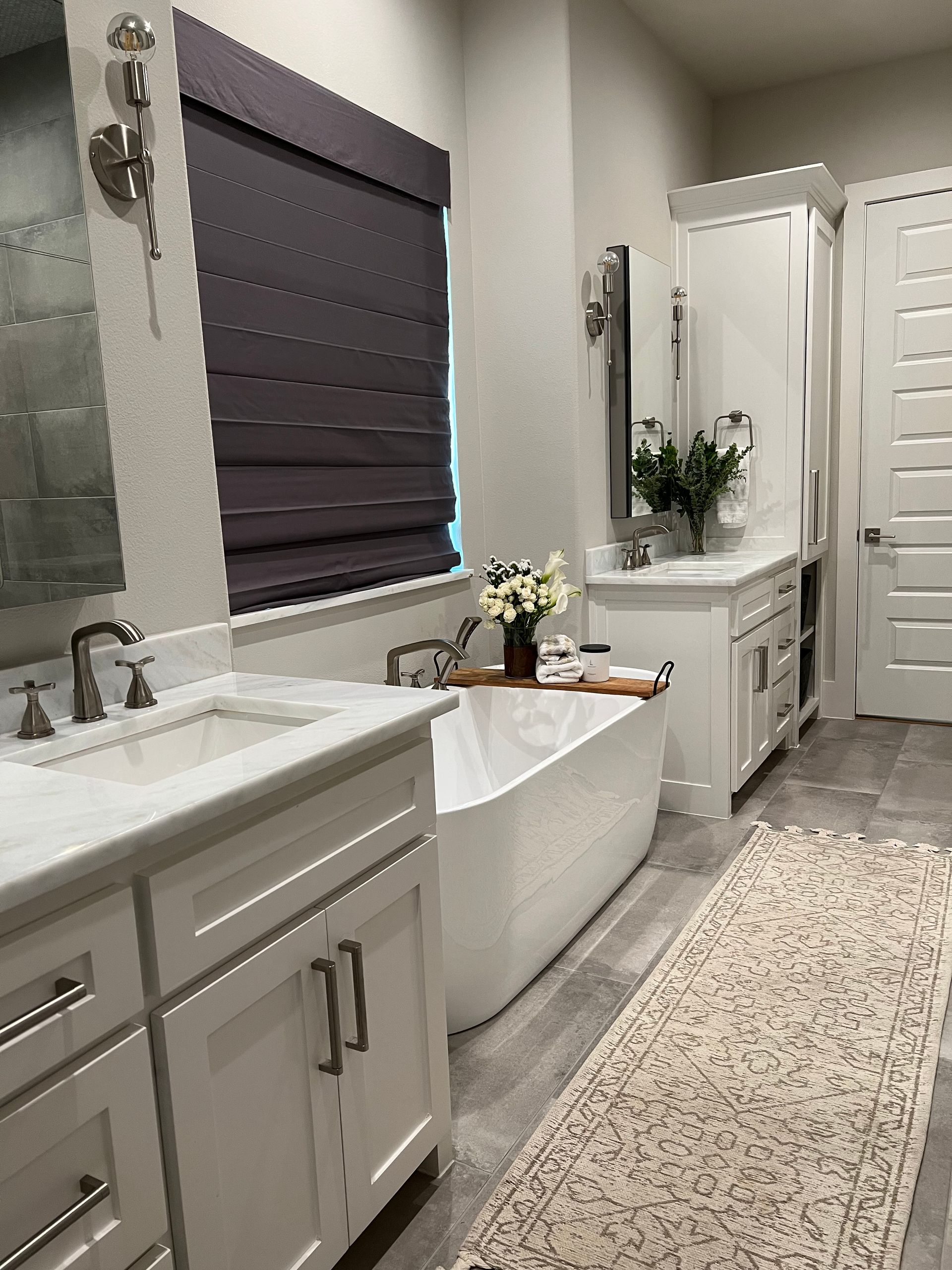 A bathroom with a tub , sink , and mirror.