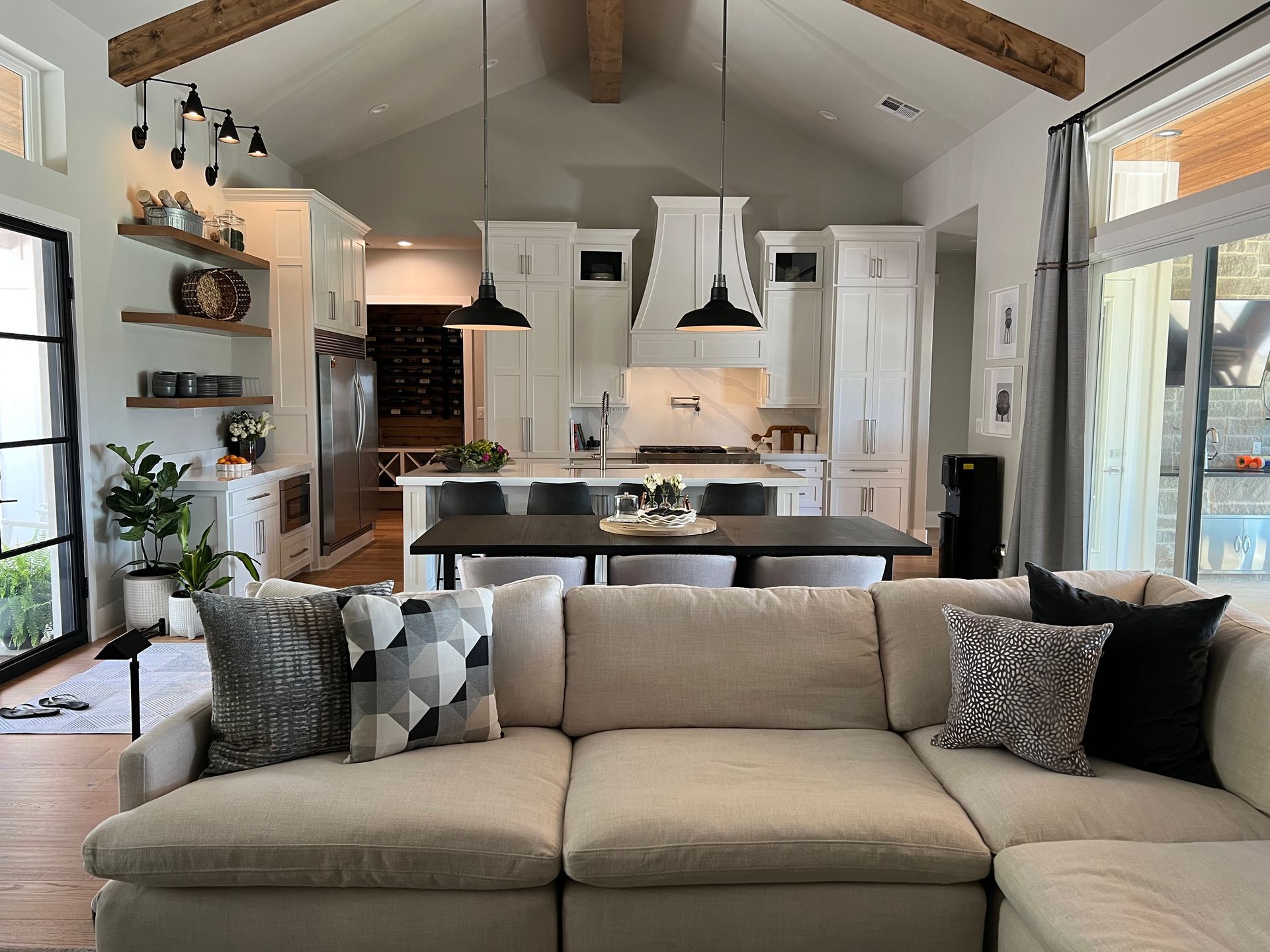 A living room with a couch and a kitchen in the background.