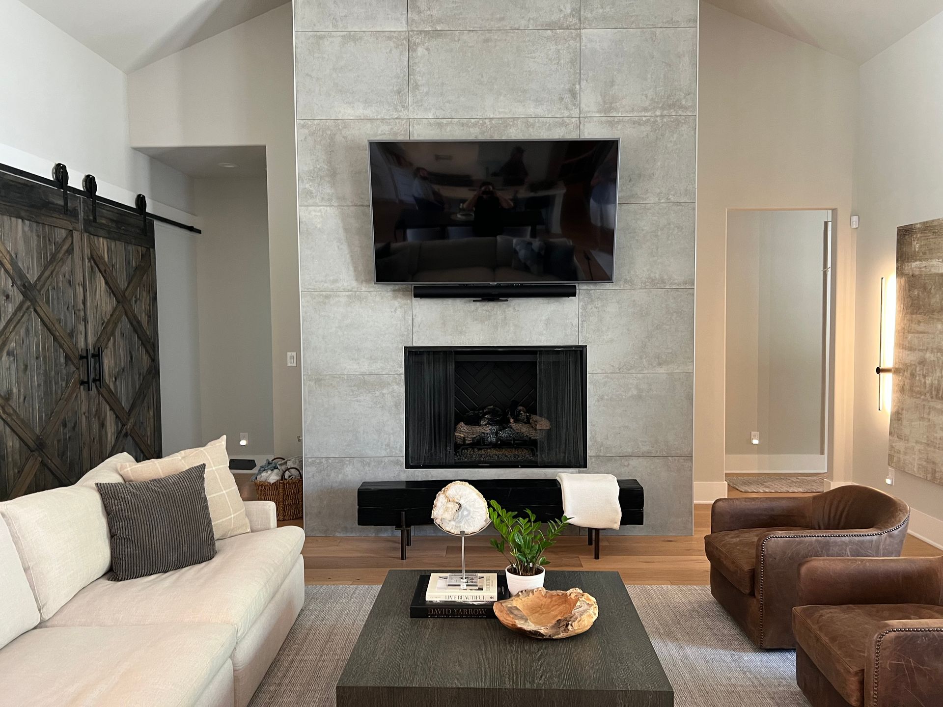 A living room with a fireplace and a flat screen tv