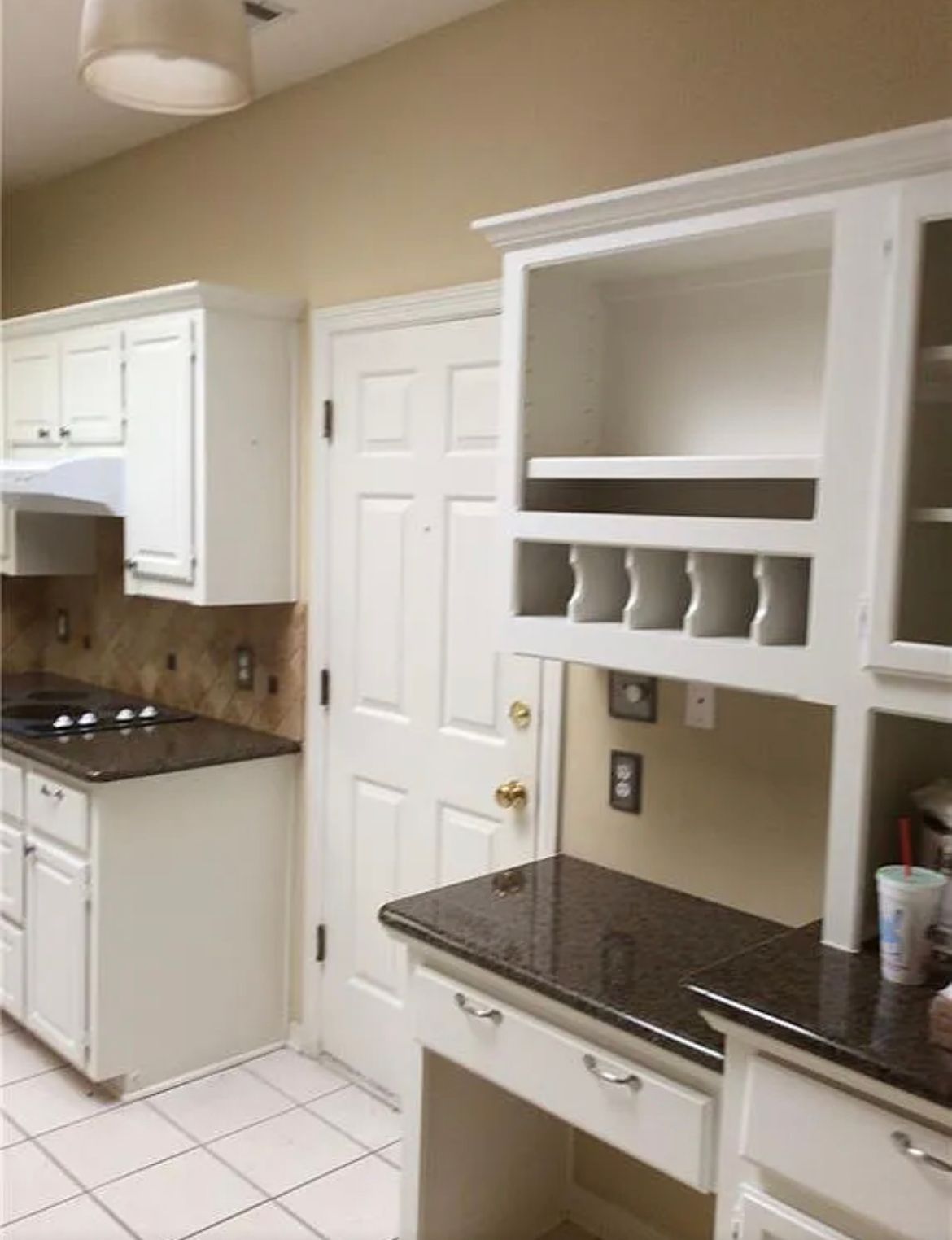 A kitchen with white cabinets and granite counter tops