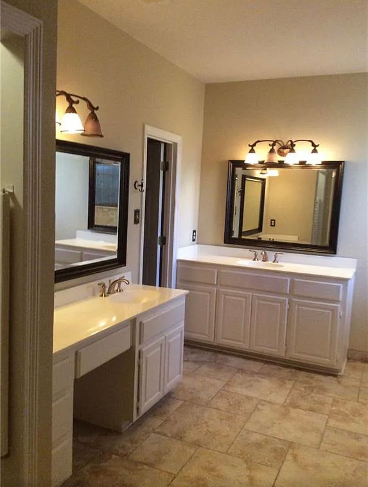 A bathroom with two sinks and two mirrors
