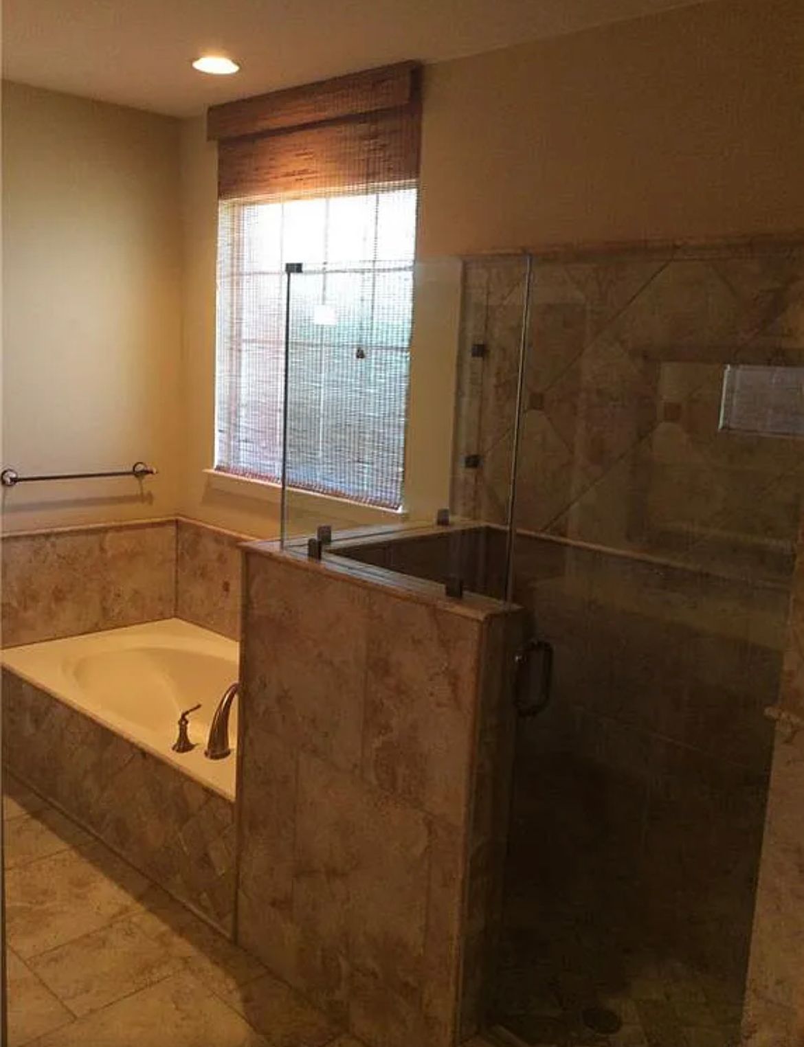 A bathroom with a tub and a walk in shower.