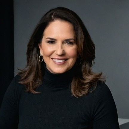 A woman in a black turtleneck is smiling for the camera.