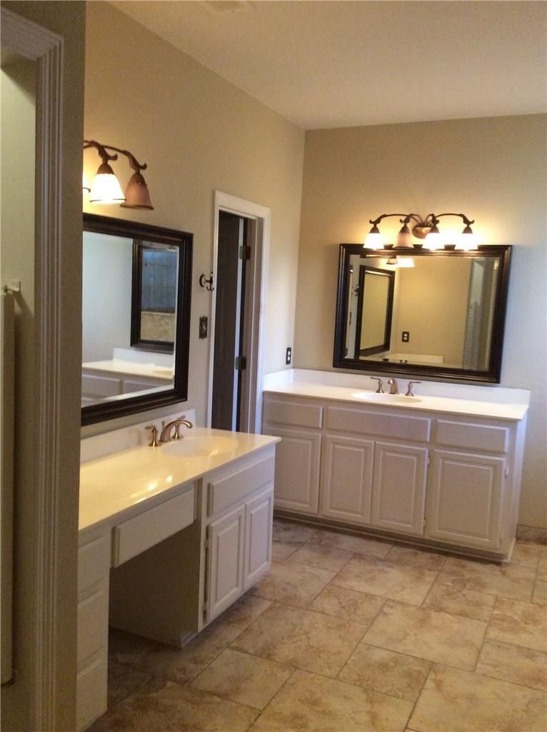 A bathroom with two sinks and two mirrors