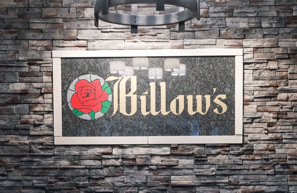 A brick wall with a sign that says ' willow 's ' on it