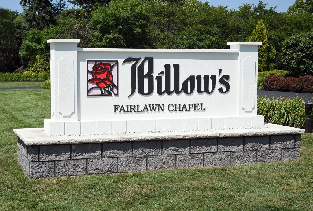 A white sign that says j billow 's fairlawn chapel
