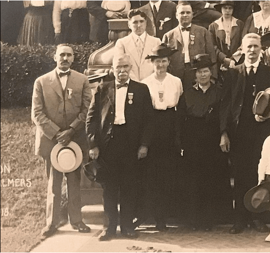 A group of people standing in front of a sign that says kansas