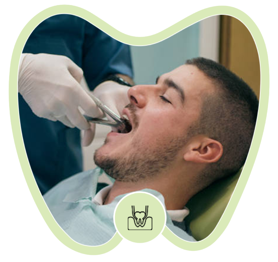A dentist in blue scrubs and white gloves uses extraction forceps to work on a patient's tooth in a dental chair.