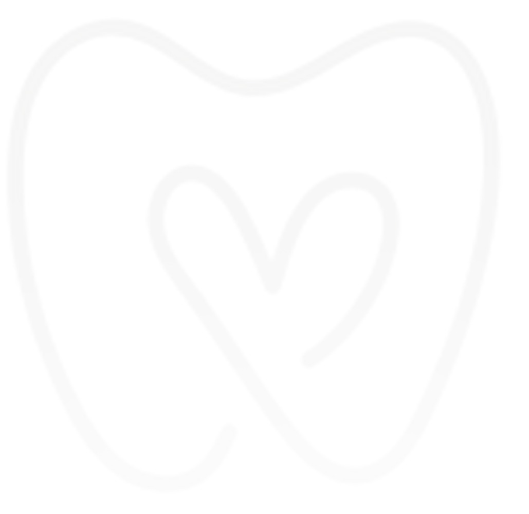 A family stands on a grassy sports field. A woman holds a young child; a man stands beside a boy wearing a team jersey.