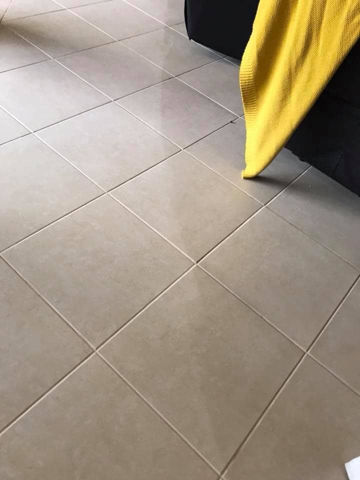 Clean Tiles Besides a Sofa and a Yellow Cloth on it — Carpet Cleaners in Tatura, VIC