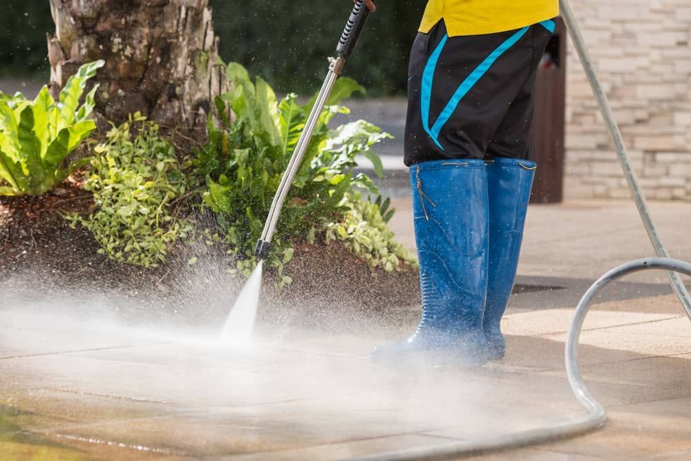 Cleaner Cleaning Outdoor Floor with Pressure Cleaning — Carpet Cleaners in Tatura, VIC