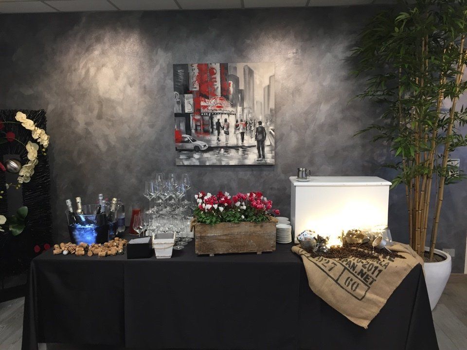 Un tavolo da buffet con un dipinto sulla parete dietro.