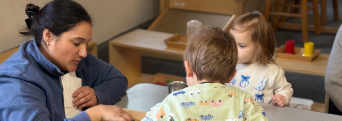 Montessori teacher with students from the caregiver program.