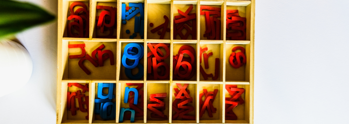 Moveable alphabet letters arranged to form cvc words in montessori classroom.