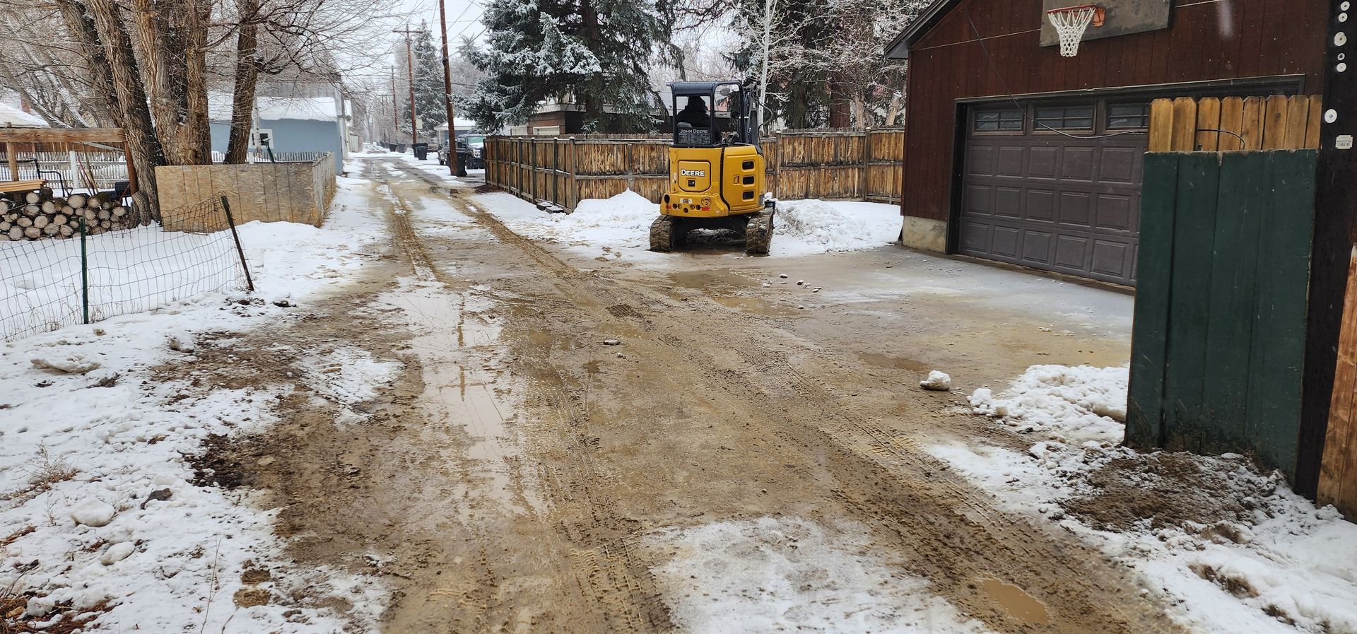 A septic tank truck is pumping water into a hole.