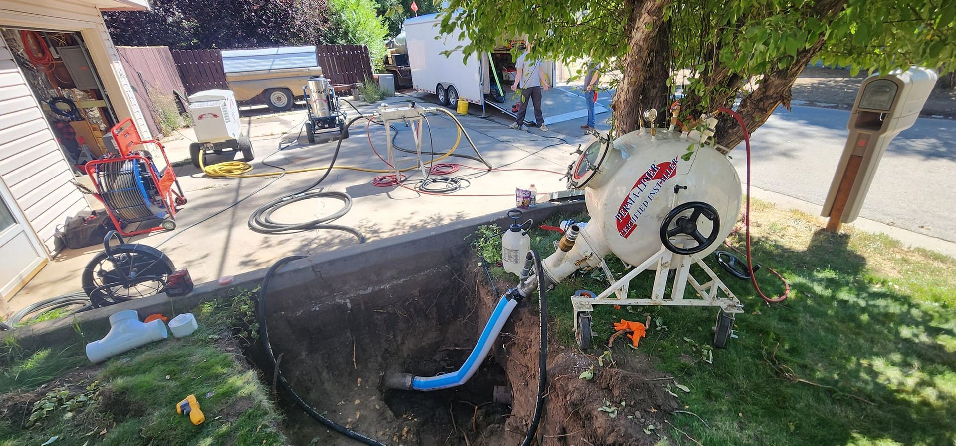 An aerial view of a hole in the ground with a hose coming out of it.