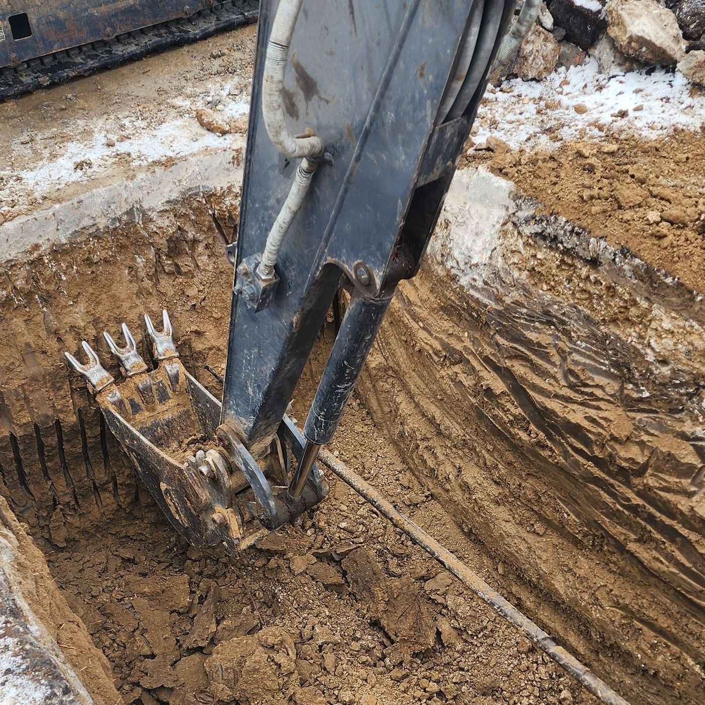 A bulldozer is digging a hole in the ground.