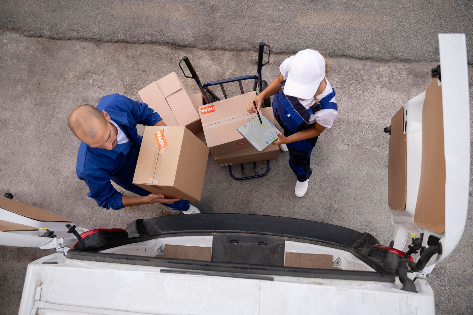 Two men loading boxes in a van