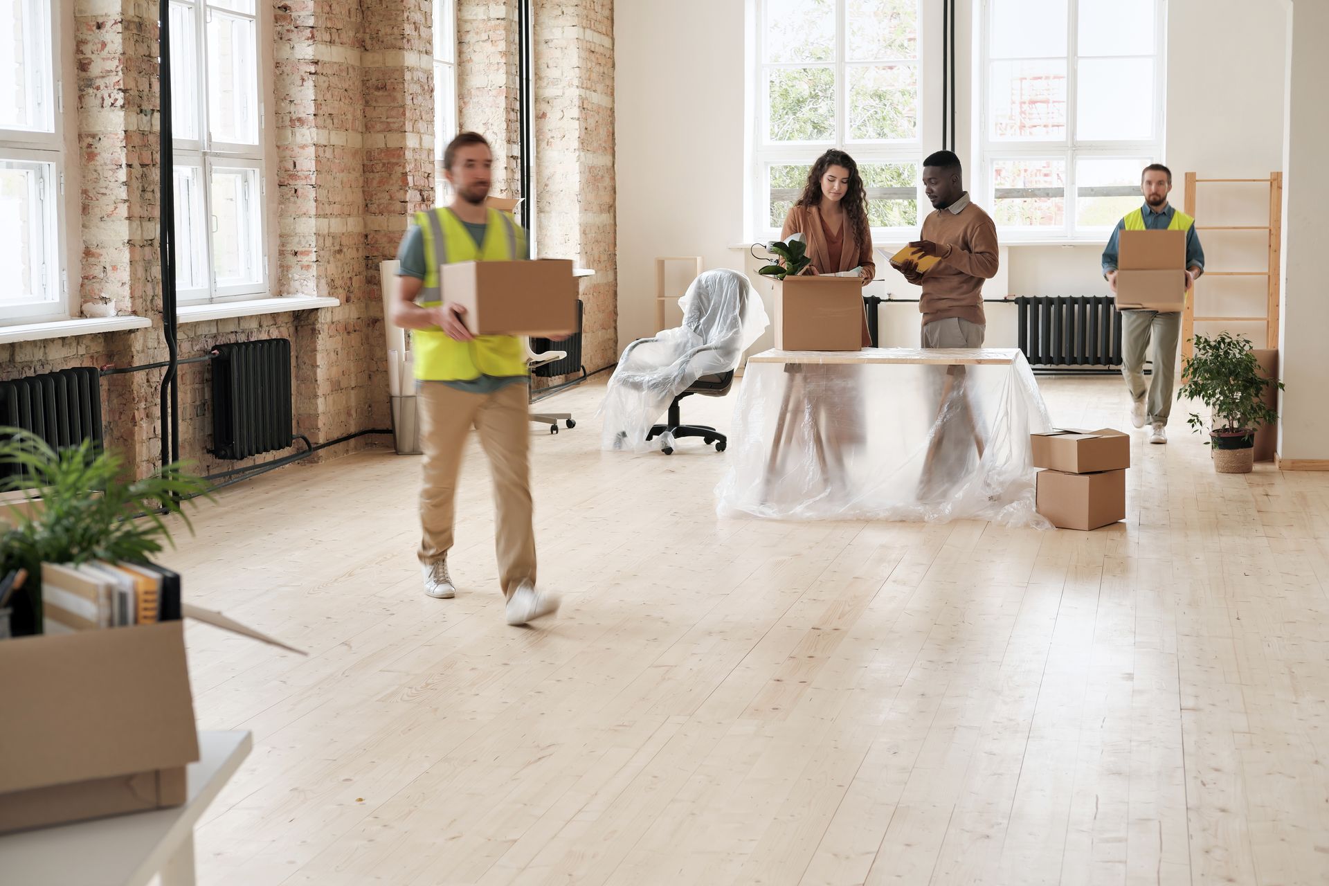 a group of people are moving into a new office .